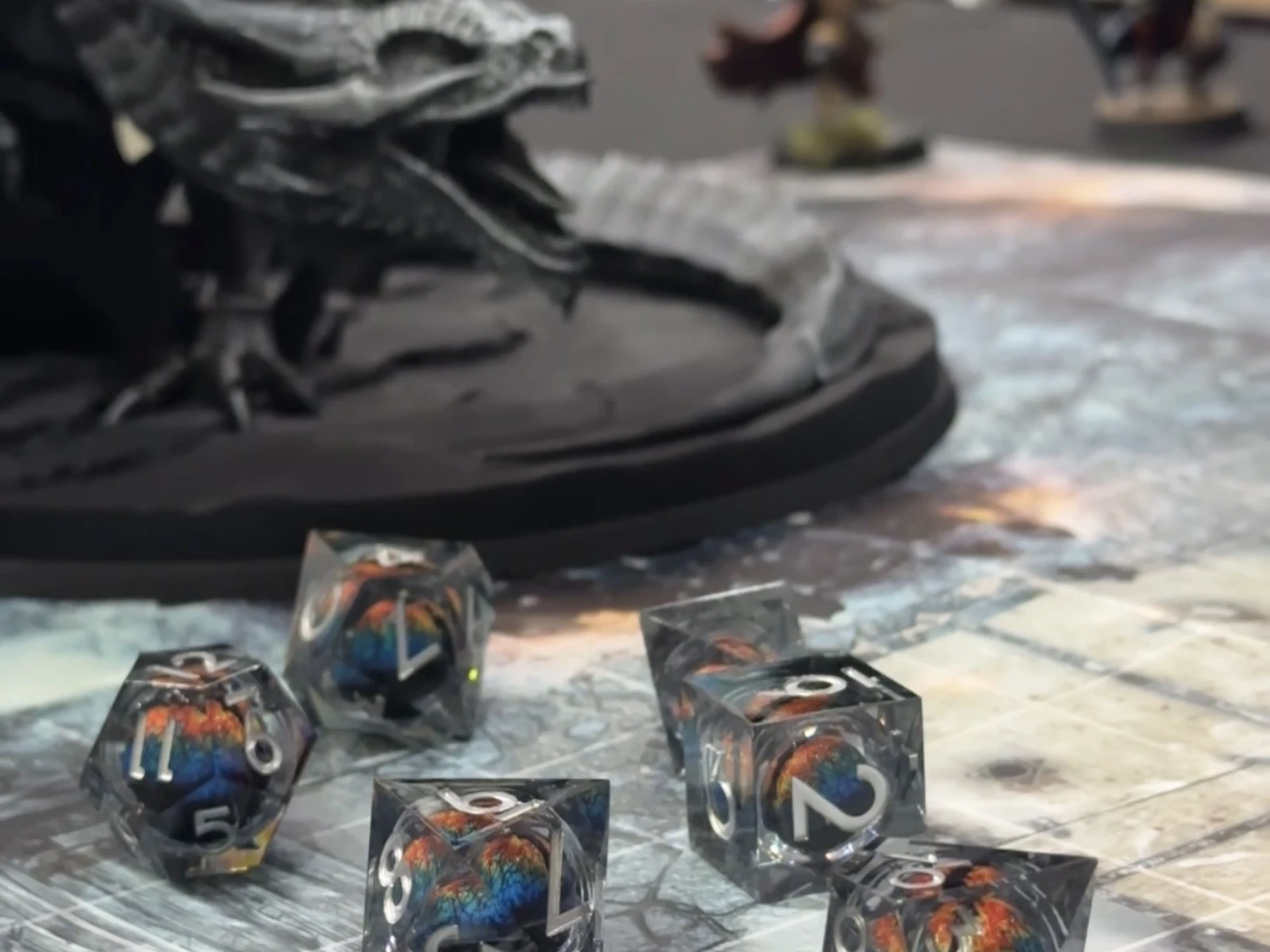 Dragon-eye dice beside the black dragon miniature on the battle map